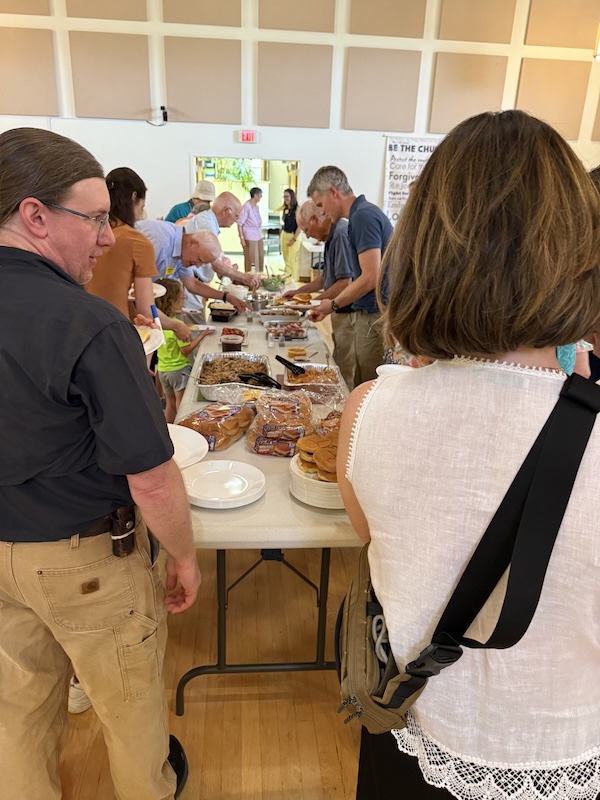 people around a table of food