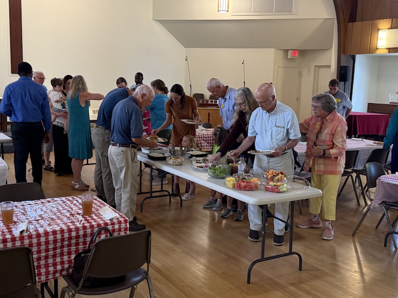 people around the serving table